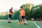 Concentrated junior soccer player running among orange cones that standing on artificial turf at stadium during workout