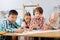 Concentrated kids drawing a bright poster in a class