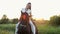 Concentrated lady rider brunette with ponytail rides horse