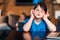 Concentrated little boy listening music in headphones