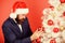 concentrated man. bearded man santa hat hold xmas ball. magic creativity. white christmas. businessman decorate new year