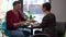 Concentrated man talking with woman in cafe calming down partner smiling. Portrait of loving caring Caucasian adult