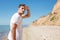 Concentrated man walking on the beach and looking far away