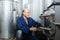 concentrated mature man working in wine secondary fermentation section