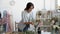 Concentrated millennial woman floral decor specialist preparing arrangement from flowers