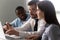 Concentrated mixed race employees listening to confident team leader.