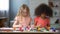 Concentrated multiracial friends painting at art school, preschool education