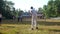 Concentrated schoolboy bats flying ball on cricket game