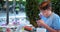 Concentrated schoolboy makes photo of sushi in restaurant