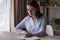 Concentrated smart young business lady making notes in planner.