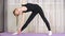 Concentrated sporty teen girl practicing yoga at home