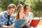 Concentrated students memorizing in a campus park