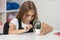 concentrated teen girl looking at plant through magnifying glass, knowledge