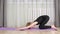 Concentrated teen girl practicing yoga on mat