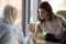 Concentrated woman arm wrestle with colleague demonstrating power