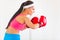 Concentrated woman in boxing gloves working out