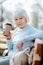 Concentrated woman drinking coffee while sitting on the bench