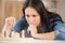 concentrated woman playing chess