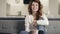 Concentrated woman sitting on sofa at kitchen. Closeup excited girl watching tv