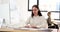 Concentrated woman types on keyboard with smile on face