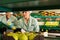 concentrated women employees in uniform sorting fresh apples on producing grading line