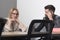 Concentrated on work. Woman and man work together at desk. Businesswoman and businessman have business meeting in office