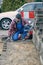 Concentrated workman laying paving bricks in winter