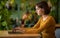 Concentrated young brunette woman developer working at cafe, using laptop