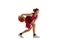 Concentration. Teen girl, basketball player in motion with ball, dribbling  over white studio background