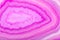 Concentric bright pink agate texture closeup