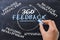 Concept of 360 degrees feedback handwritten on chalkboard by businesswoman hand