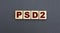 Concept acronym PSD2 on wooden cubes on a gray background
