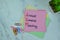 Concept of AGM - Annual General Meeting write on sticky notes isolated on Wooden Table