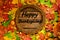 The concept of autumn wallpaper. Dried maple leaves and acorns lined with a round frame with text: Happy Thanksgiving.