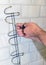 Concept of bathroom remodeling. installation of hanger, towel holder with a screwdriver