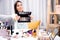 Concept beauty school online. Woman blogger makeup artist with brushes palette powder