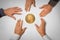 Concept of a bitcoin hype with five hands reaching for a bitcoin coin