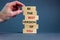 Concept of building success foundation. Men hand put wooden blocks on the stack of wooden blocks. Text `be the best version of yo