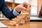 Concept of Business growth, Businessman success for career, Close up hand of man has piling up and stacking a wooden block