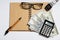 Concept of business, top view, calculator, pen, glasses, notebook written with tax on a white background, copy space