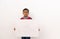 Concept of child protest showing with young boy holding large white placard on isolated background.