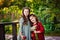 The concept of childhood, family and natural beauty. The sisters are walking in the Park with a basket of apples and daisies.