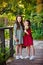 The concept of childhood, family and natural beauty. The sisters are walking in the Park with a basket of apples and daisies.