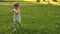 Concept of childish happiness. Happy child runs on a meadow in summer on a green grass. cheerful little girl runs across