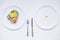 Concept of choice - healthy food or medical pills, top view on the white plate and wooden table. Choice between natural and synthe