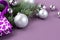 The concept of a Christmas background. Top view of silver balls from a Christmas gift box with fir branches on a