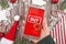 Concept for Christmas seasonal online shopping and sales with hand holding cell phone with `Buy` sign button in red background