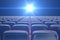 Concept cinema, shining blue color in movie theater. Rows of chairs with empty seats. 3d illustration