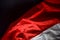 Concept closeup waving abstract fabric Indonesia independence day flag on Black background