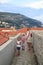 concept of cognitive recreation with children. traveling mother, daughter and son on the walls enclosing the old town of Dubrovnik